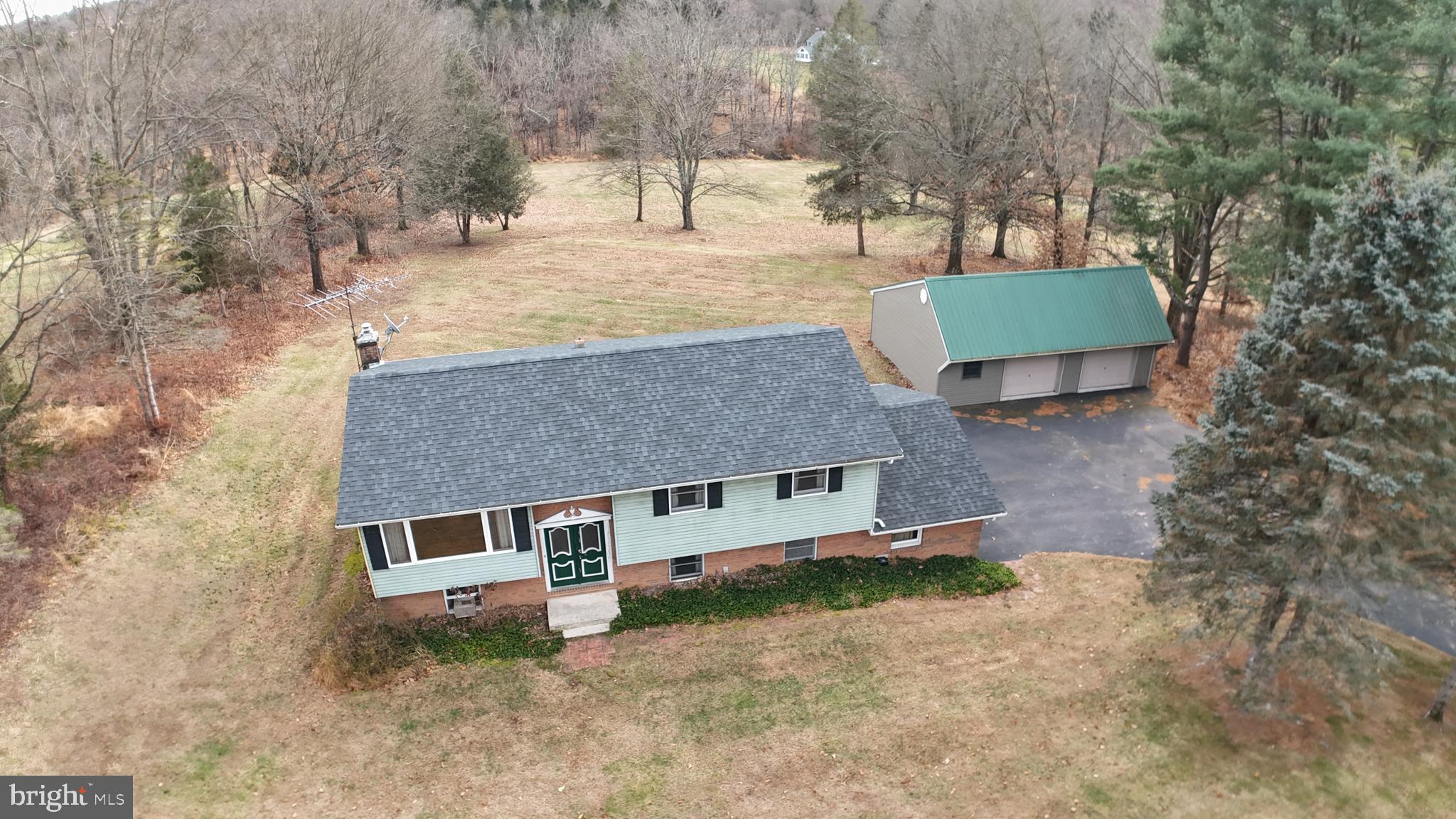 a view of a house with a yard and a tree
