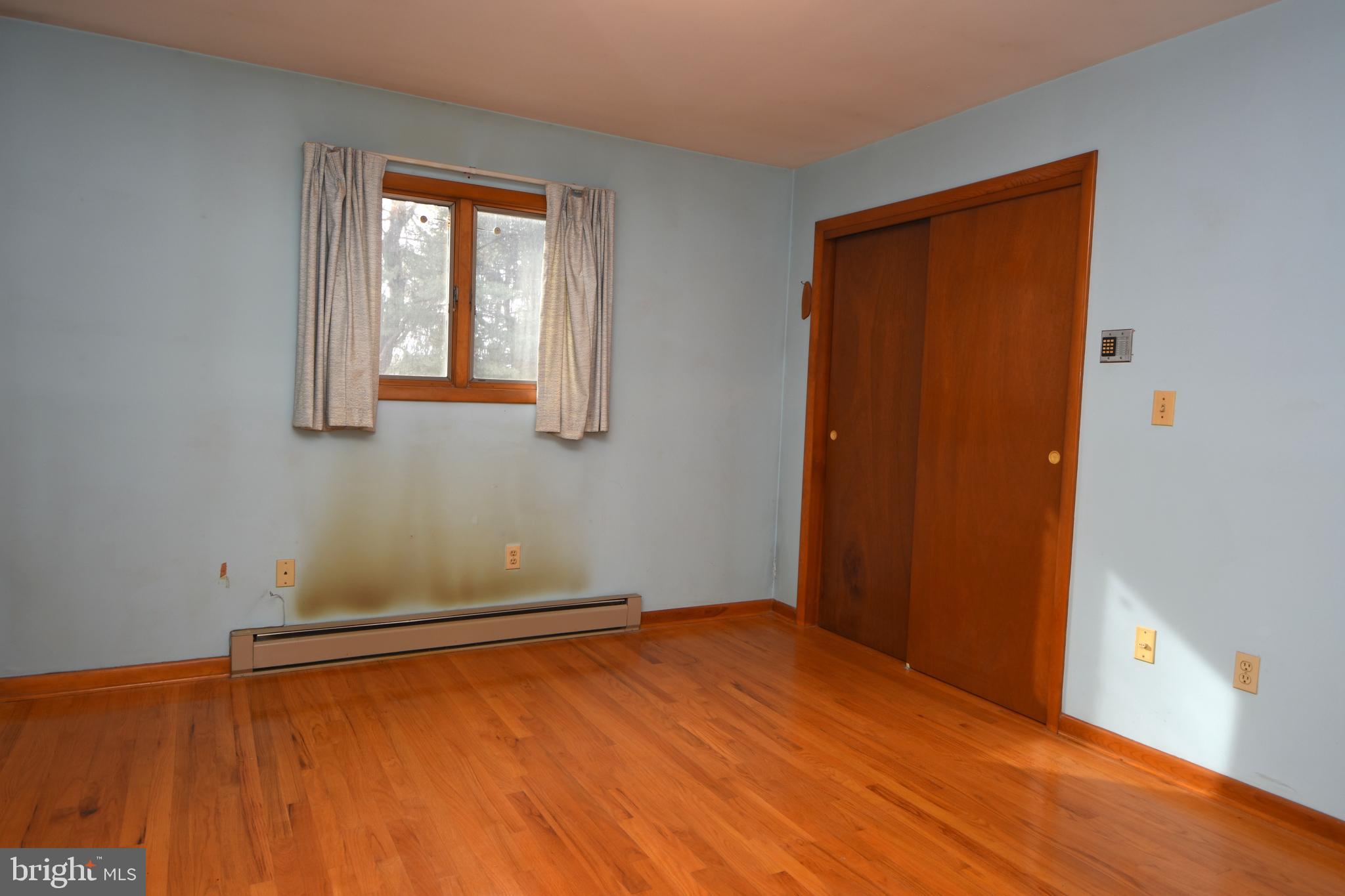 3288 Slifer Valley Road Riegelsville, PA 18077 - Photo 17 of 36 an empty room with wooden floor and windows