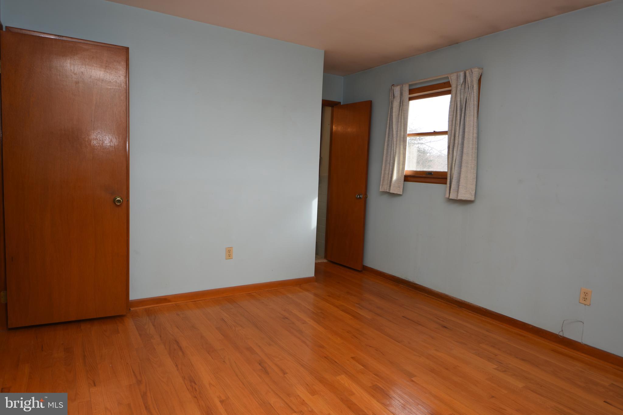 3288 Slifer Valley Road Riegelsville, PA 18077 - Photo 18 of 36 an empty room with wooden floor and windows