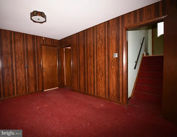 a view of an empty room with wooden walls