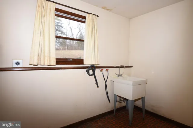 a bathroom with a sink toilet and mirror