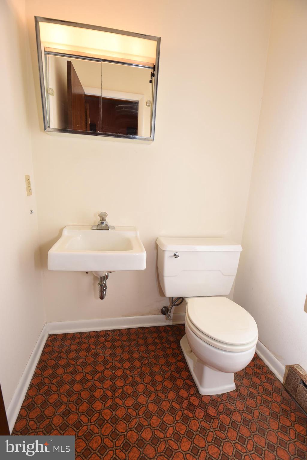 3288 Slifer Valley Road Riegelsville, PA 18077 - Photo 23 of 36 a bathroom with a sink toilet and mirror