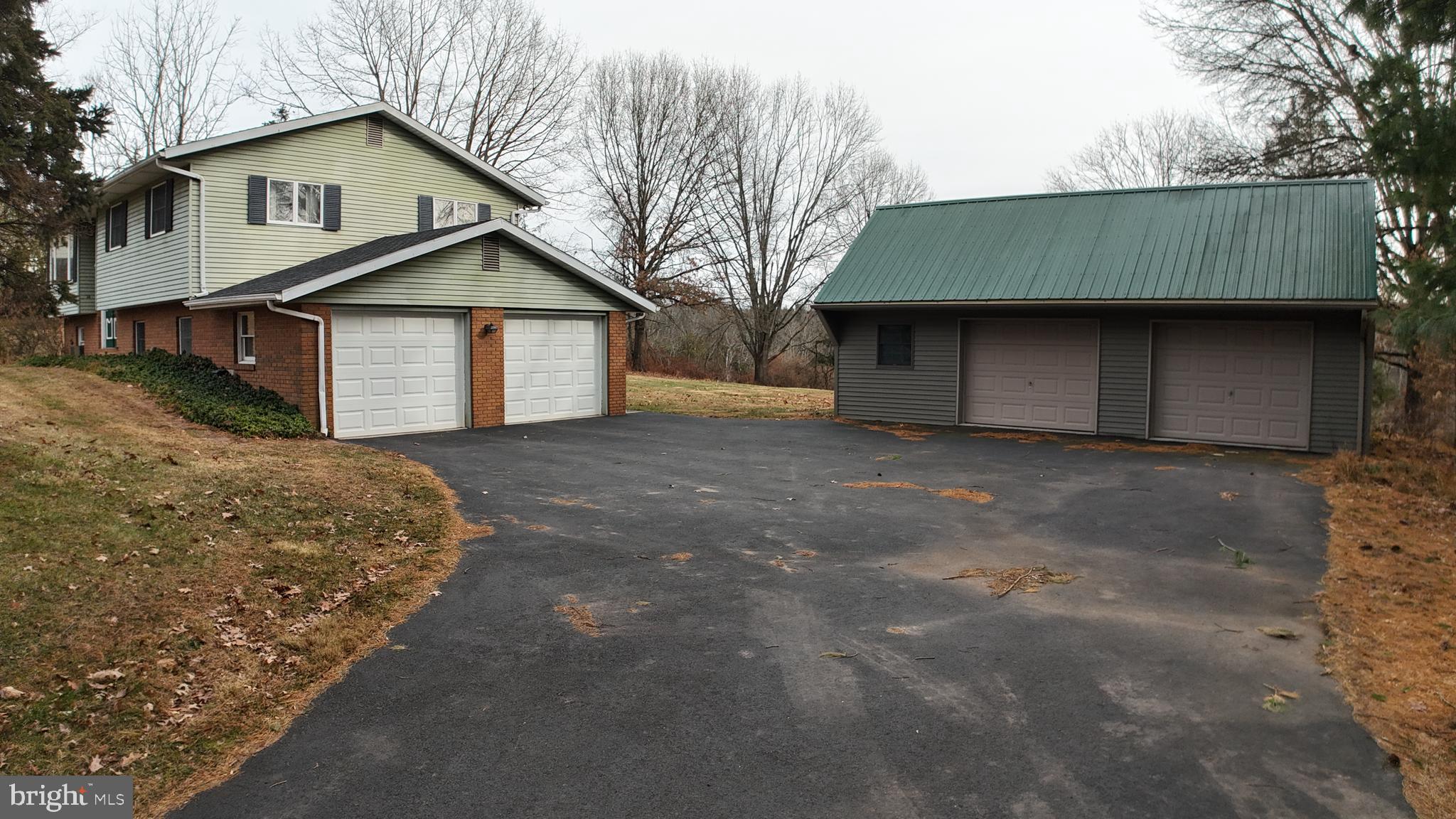 3288 Slifer Valley Road Riegelsville, PA 18077 - Photo 3 of 36 a front view of a house with a yard and garage