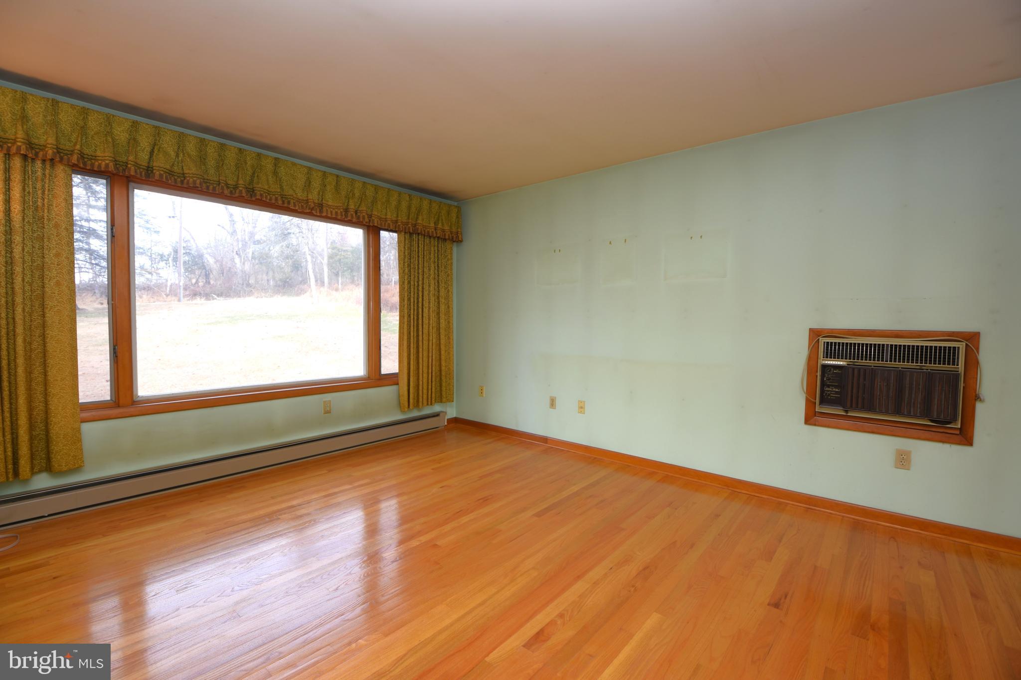 3288 Slifer Valley Road Riegelsville, PA 18077 - Photo 9 of 36 a view of an empty room with a window and wooden floor