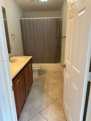 a bathroom with a sink a toilet and a shower