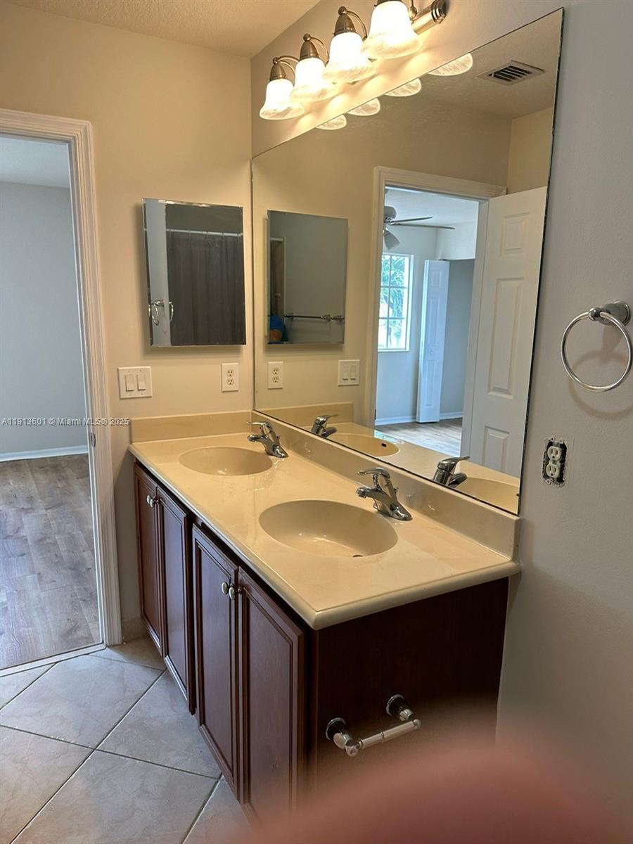 9113 Chambers Street Tamarac, FL 33321 - Photo 12 of 13 a bathroom with a sink and a mirror