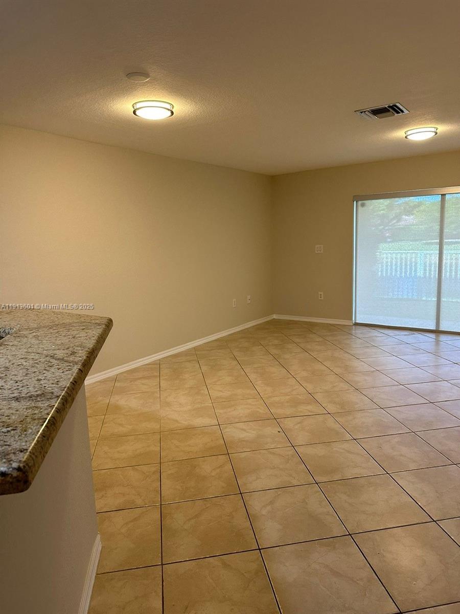9113 Chambers Street Tamarac, FL 33321 - Photo 4 of 13 a view of an empty room and window