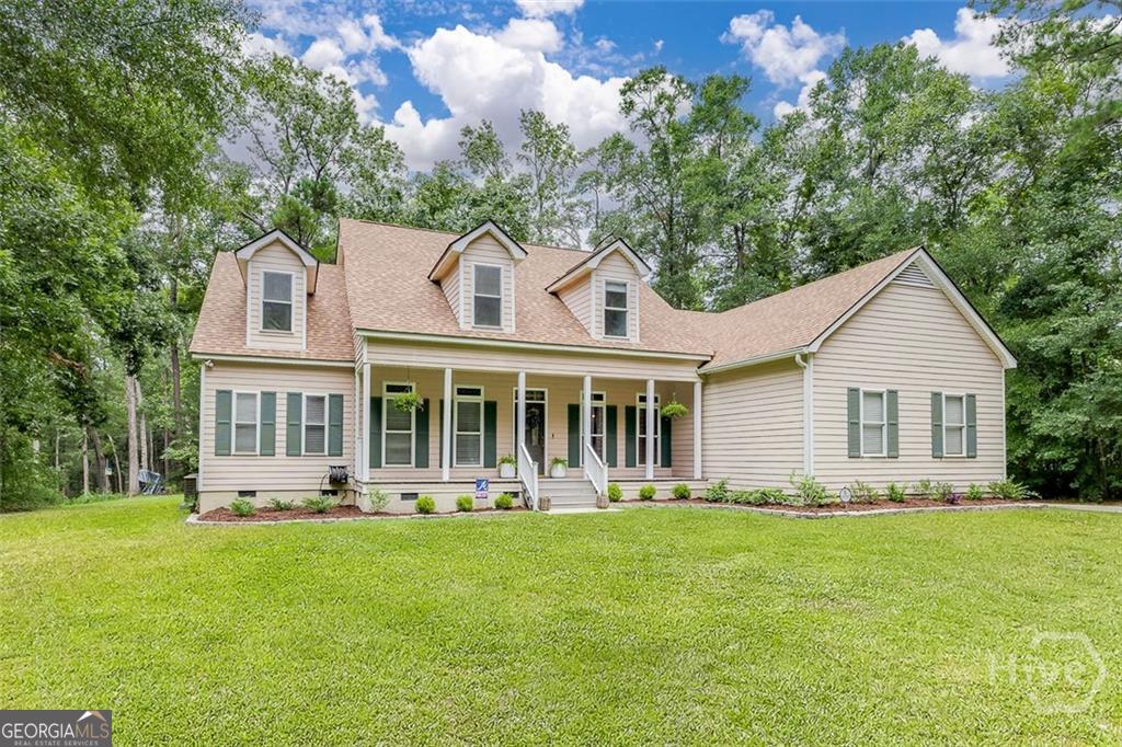 a front view of house with yard and green space