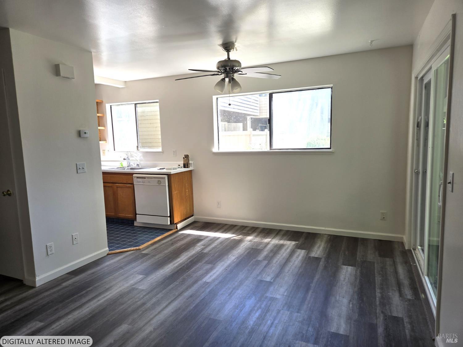 2125 West Steele Lane Santa Rosa, CA 95403 - Photo 3 of 16 a view of an empty room with window wooden floor and a kitchen
