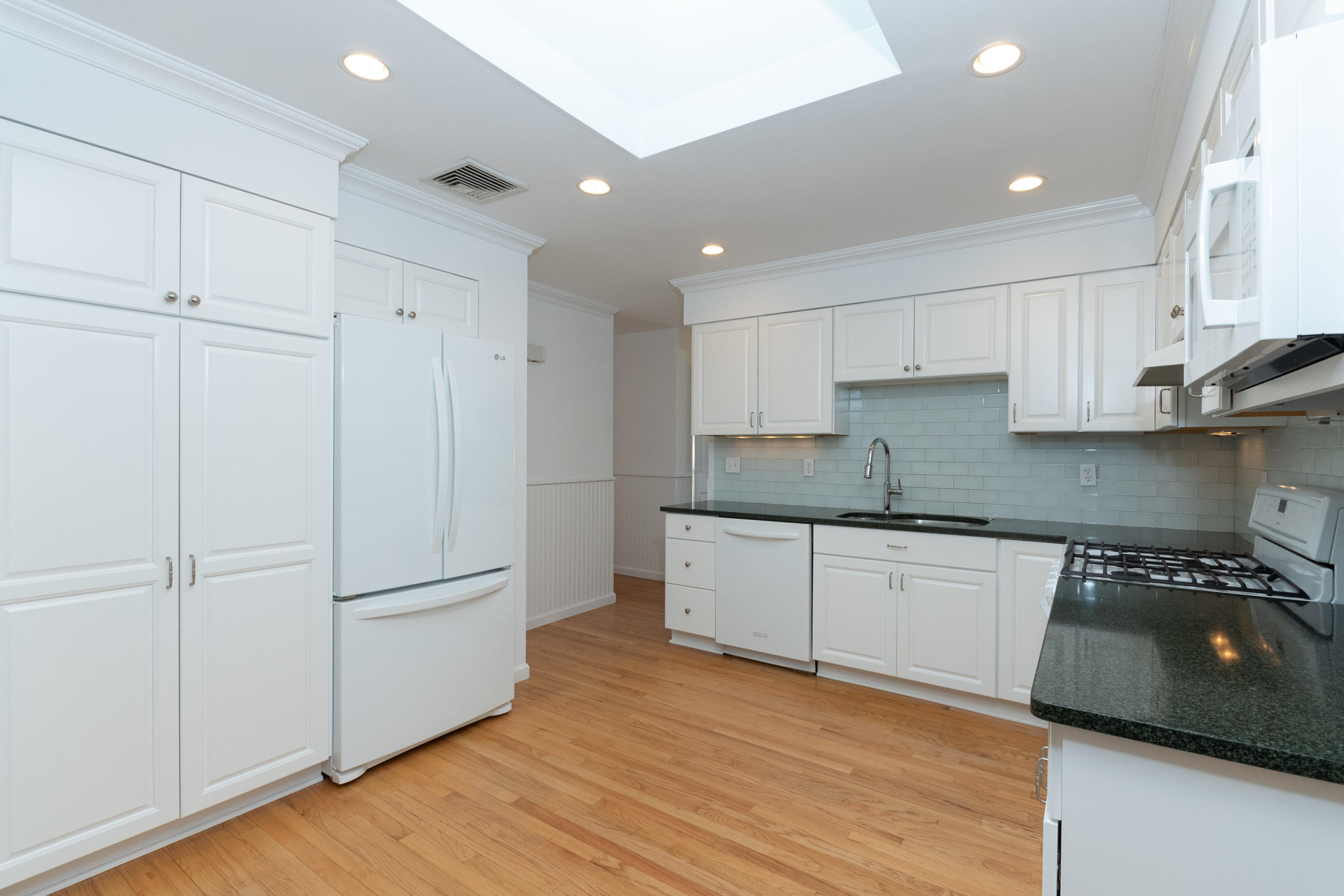 11 Cottontail Road Norwalk, CT 06854 - Photo 13 of 51 a kitchen with granite countertop white cabinets and white appliances