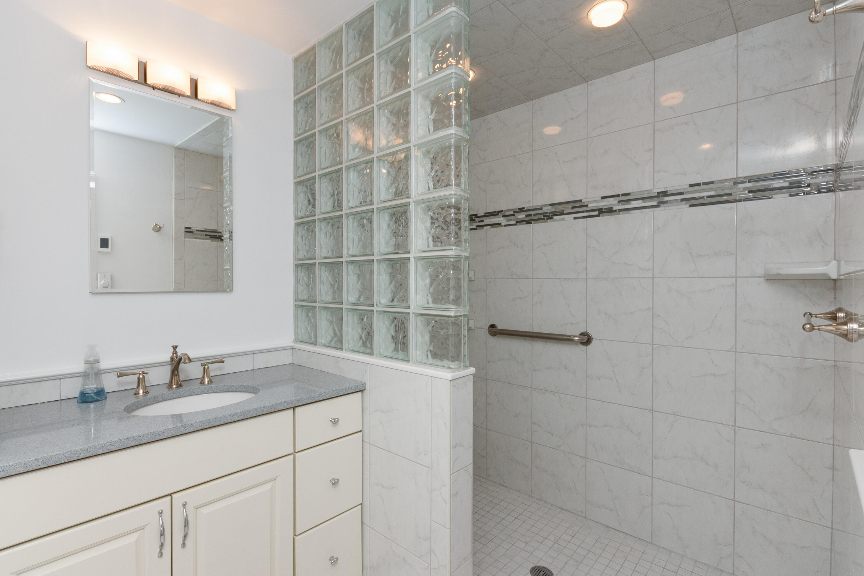 11 Cottontail Road Norwalk, CT 06854 - Photo 25 of 51 a bathroom with a granite countertop sink a mirror and shower
