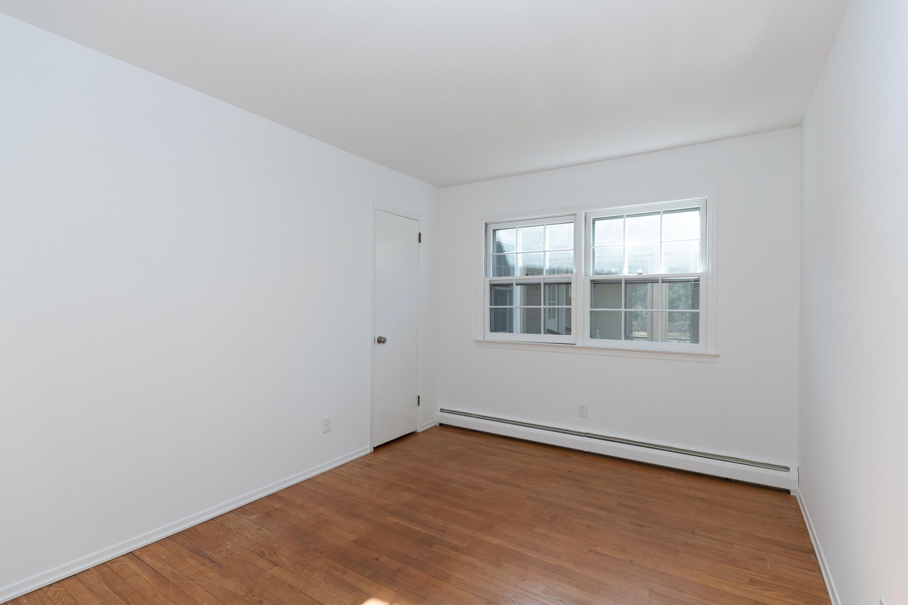11 Cottontail Road Norwalk, CT 06854 - Photo 33 of 51 an empty room with wooden floor and windows