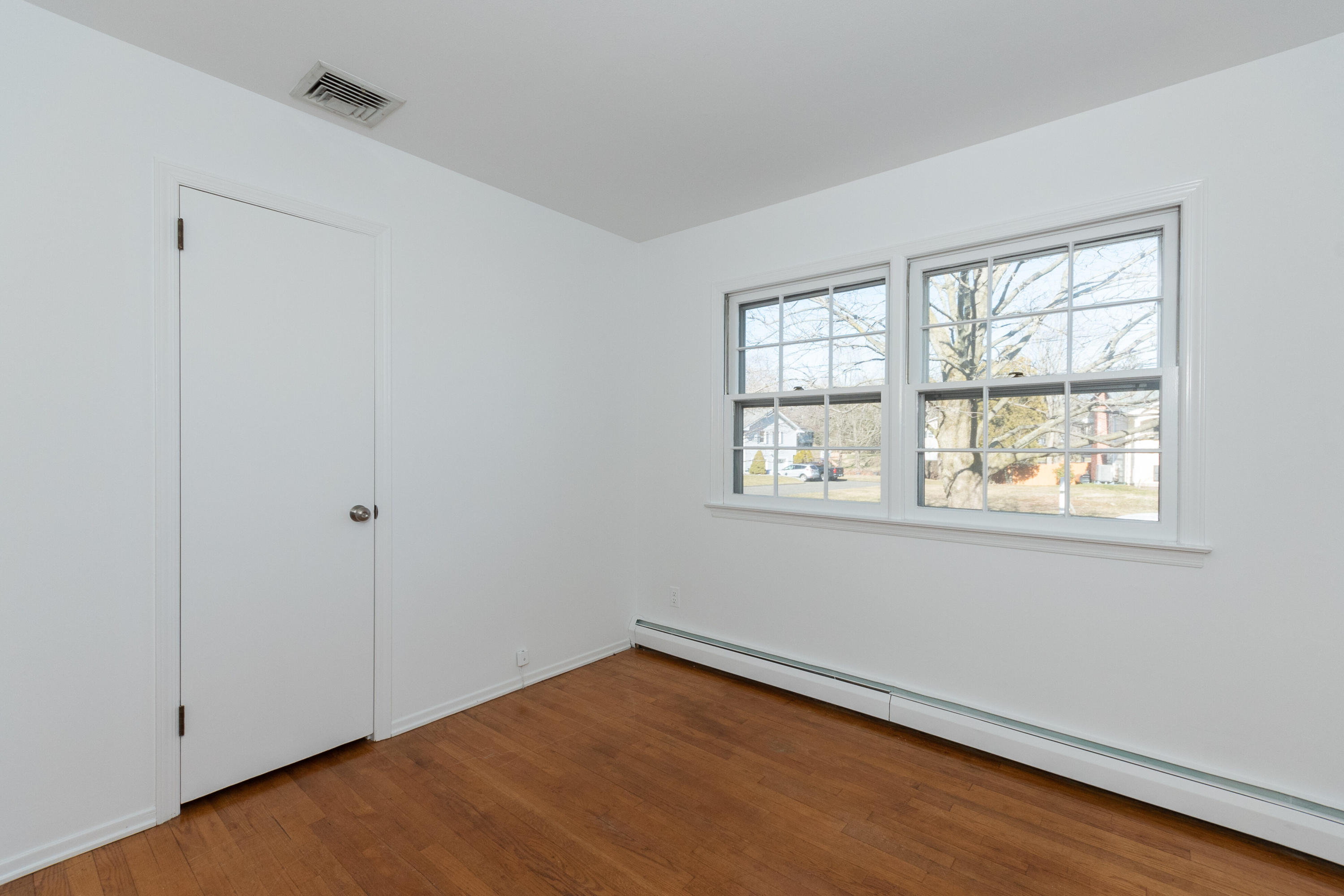11 Cottontail Road Norwalk, CT 06854 - Photo 35 of 51 a view of an empty room with wooden floor and a window