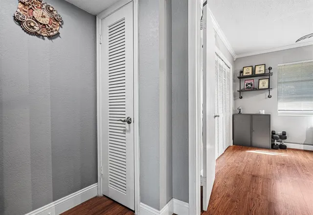 a view of a bedroom with wooden floor and closet