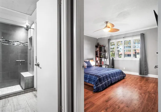 a bedroom with a bed and a chandelier