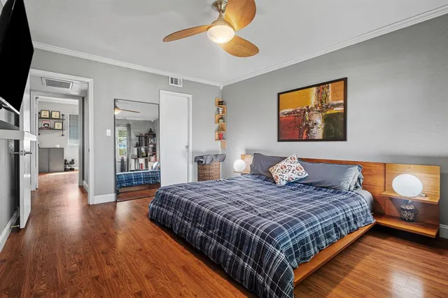 a bedroom with a large bed and a chandelier