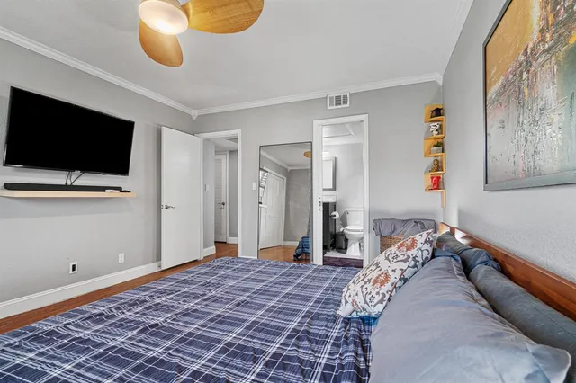 a bedroom with a bed and flat screen tv