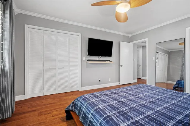 a bedroom with a bed and flat screen tv