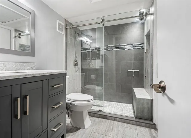 a bathroom with a sink toilet and shower
