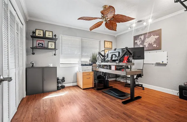 a view of a workspace with furniture and a window
