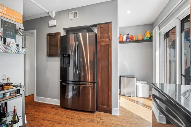 a kitchen with stainless steel appliances granite countertop a refrigerator and a sink