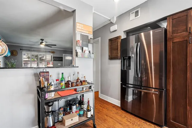 a kitchen with stainless steel appliances granite countertop a refrigerator and a stove