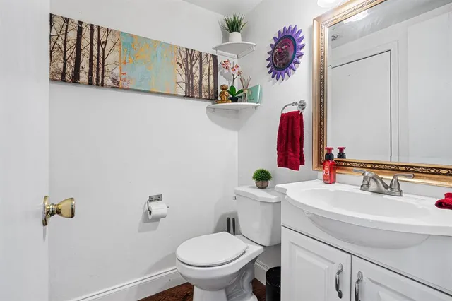 a bathroom with a sink mirror vanity and toilet