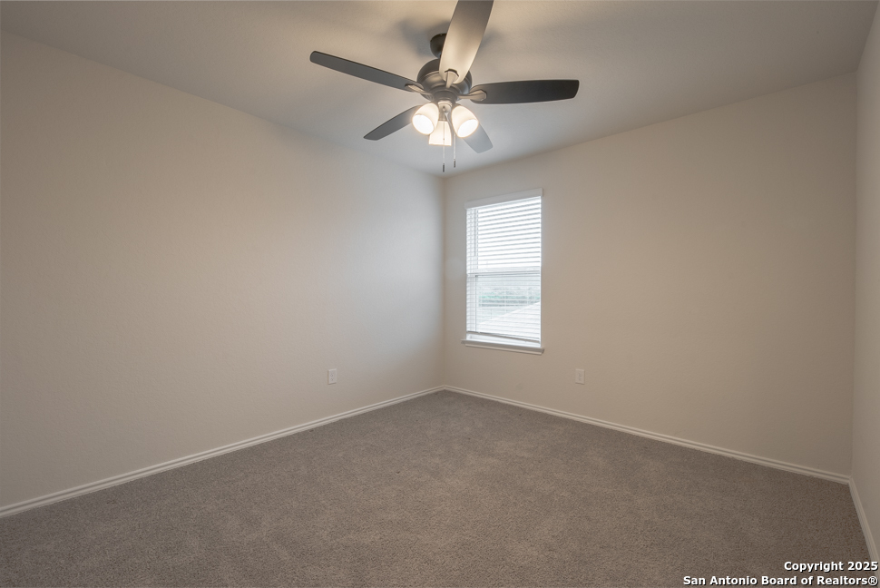 3934 Copper River Bulverde, TX 78163 - Photo 20 of 28 an empty room with a window and a fan