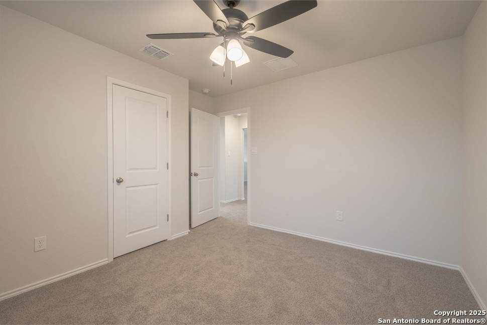 3934 Copper River Bulverde, TX 78163 - Photo 21 of 28 an empty room with a chandelier fan and windows