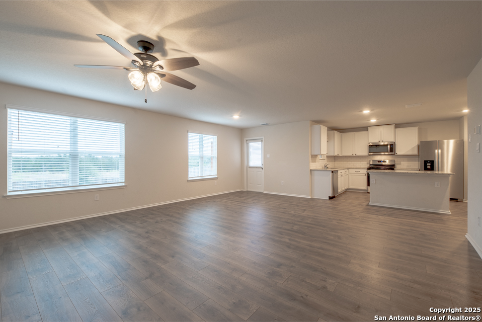 3934 Copper River Bulverde, TX 78163 - Photo 6 of 28 a view of an empty room with wooden floor and a window