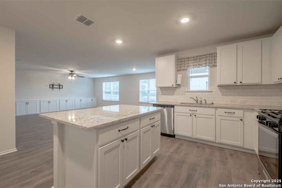 3934 Copper River Bulverde, TX 78163 - Photo 9 of 28 a kitchen with granite countertop a sink stove and cabinets