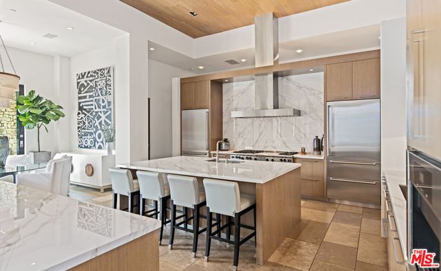 a dining room with chandelier fan and wooden floor