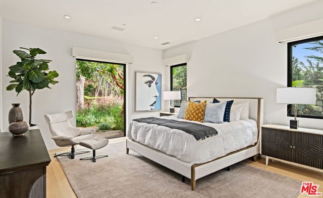 a bedroom with a bed and a large window