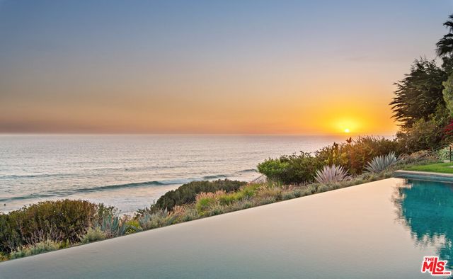 a bedroom with furniture and a flat screen tv