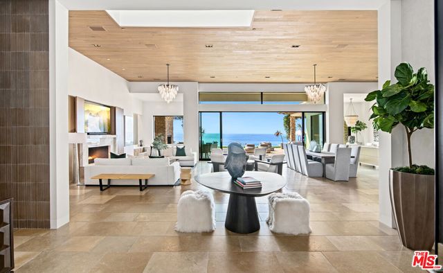 a living room with furniture and a chandelier