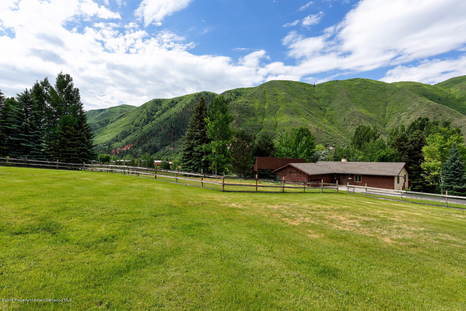 142 Holland Hills Road Basalt, CO 81621 - Photo 8 of 29 a view of a swimming pool with lawn chairs with plants