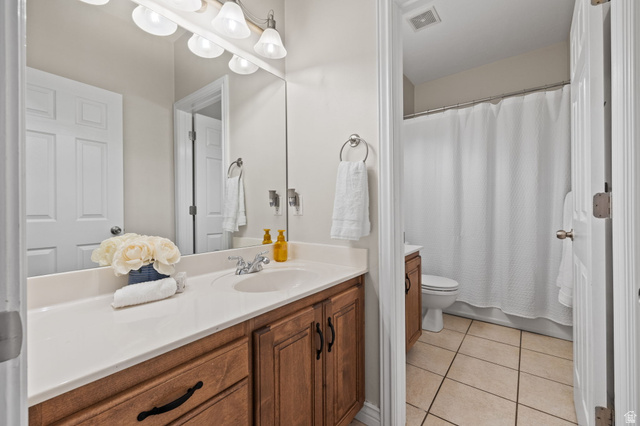 6208 West Bull River Road Highland, UT 84003 - Photo 41 of 90 Bathroom vanity with a single basin sink, light-toned countertop, wood-finish cabinetry, and an overhead vanity light fixture