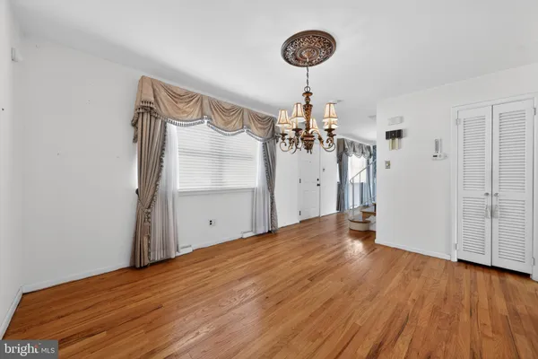 a view of a room with wooden floor