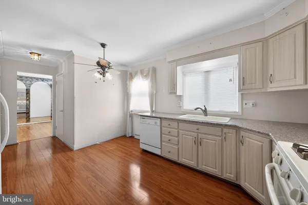a spacious bathroom with a granite countertop sink a mirror and shower view