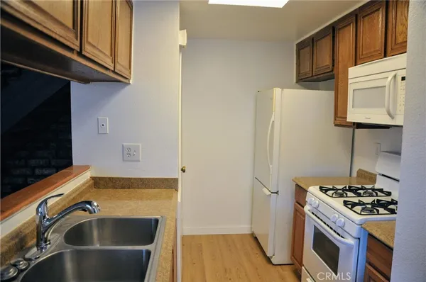 a kitchen with stainless steel appliances a stove a sink and a refrigerator