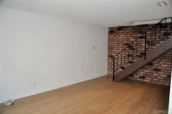 a view of an empty room with closet and a window