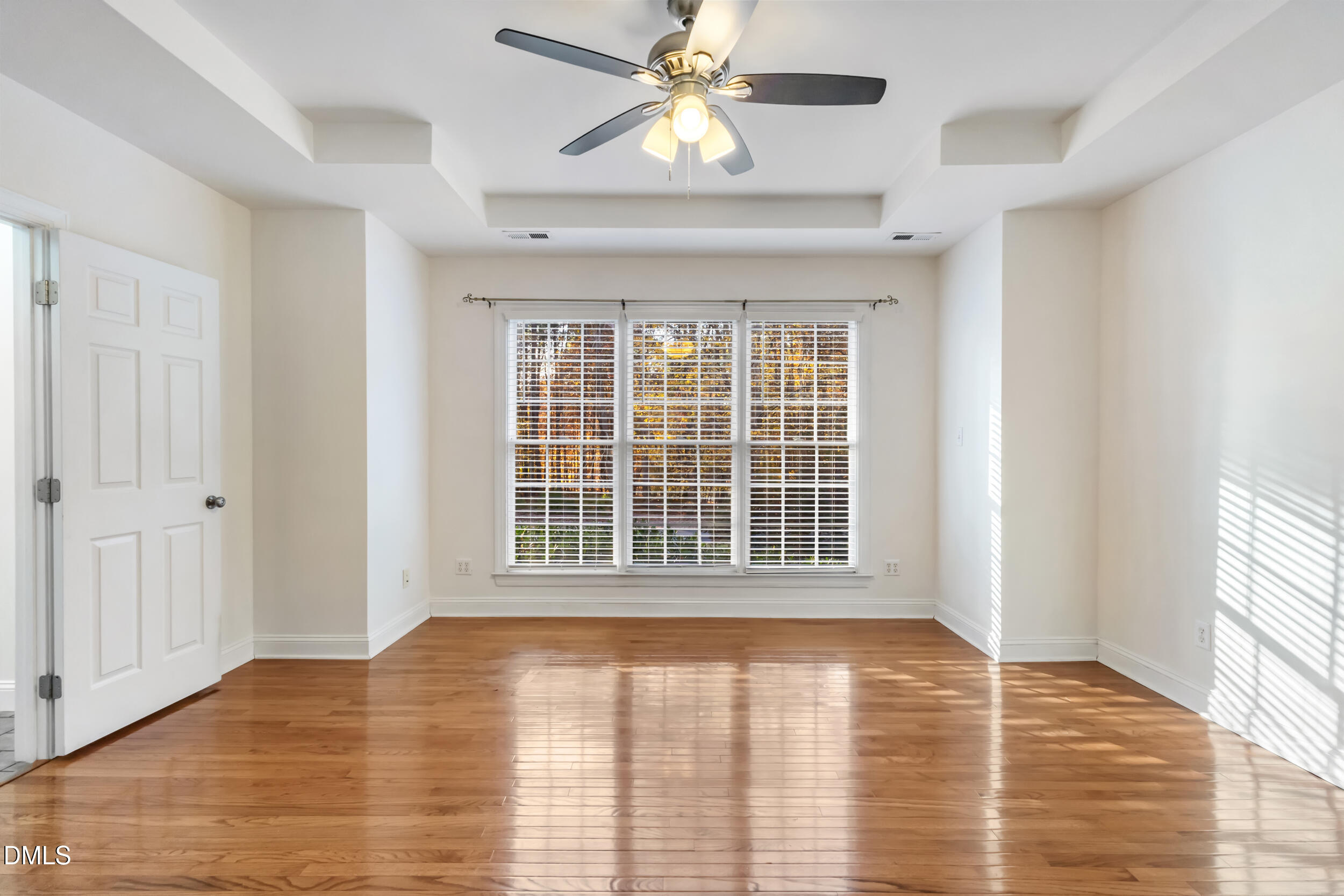 6816 Cool Pond Road Raleigh, NC 27613 - Photo 22 of 65 a view of an empty room with window and wooden floor