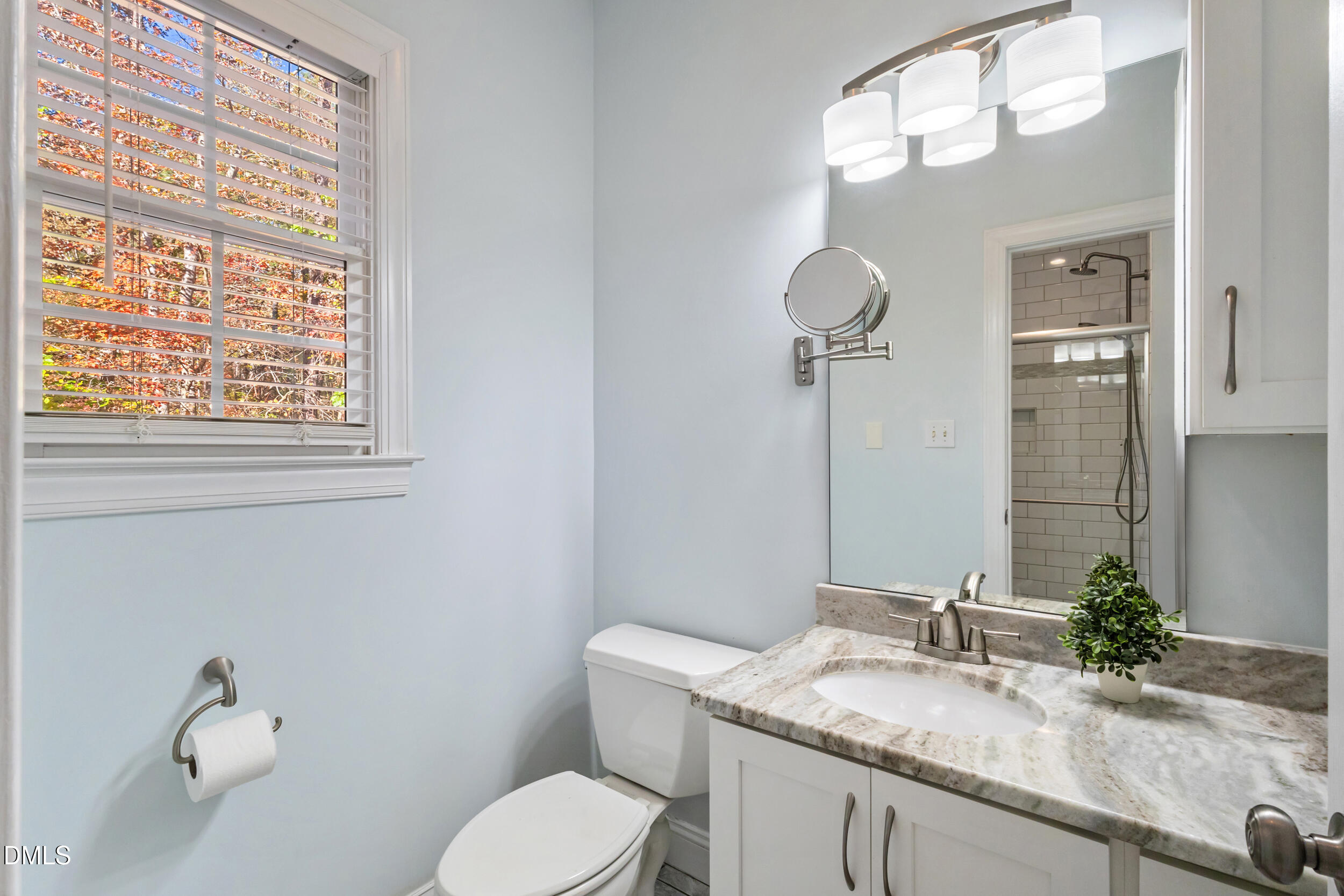 6816 Cool Pond Road Raleigh, NC 27613 - Photo 27 of 65 a bathroom with a granite countertop toilet sink and mirror