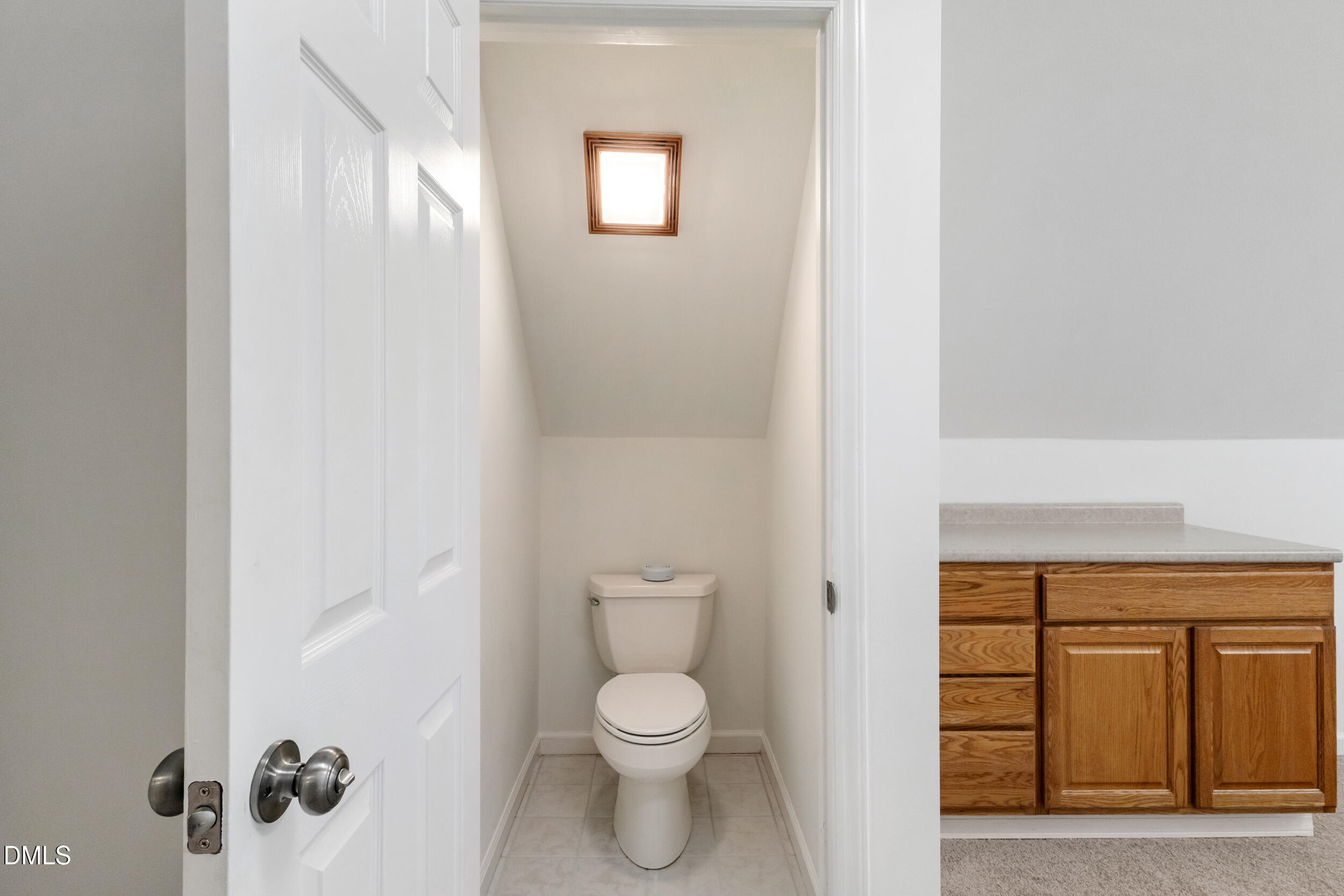 6816 Cool Pond Road Raleigh, NC 27613 - Photo 31 of 65 a bathroom with a toilet a sink and mirror