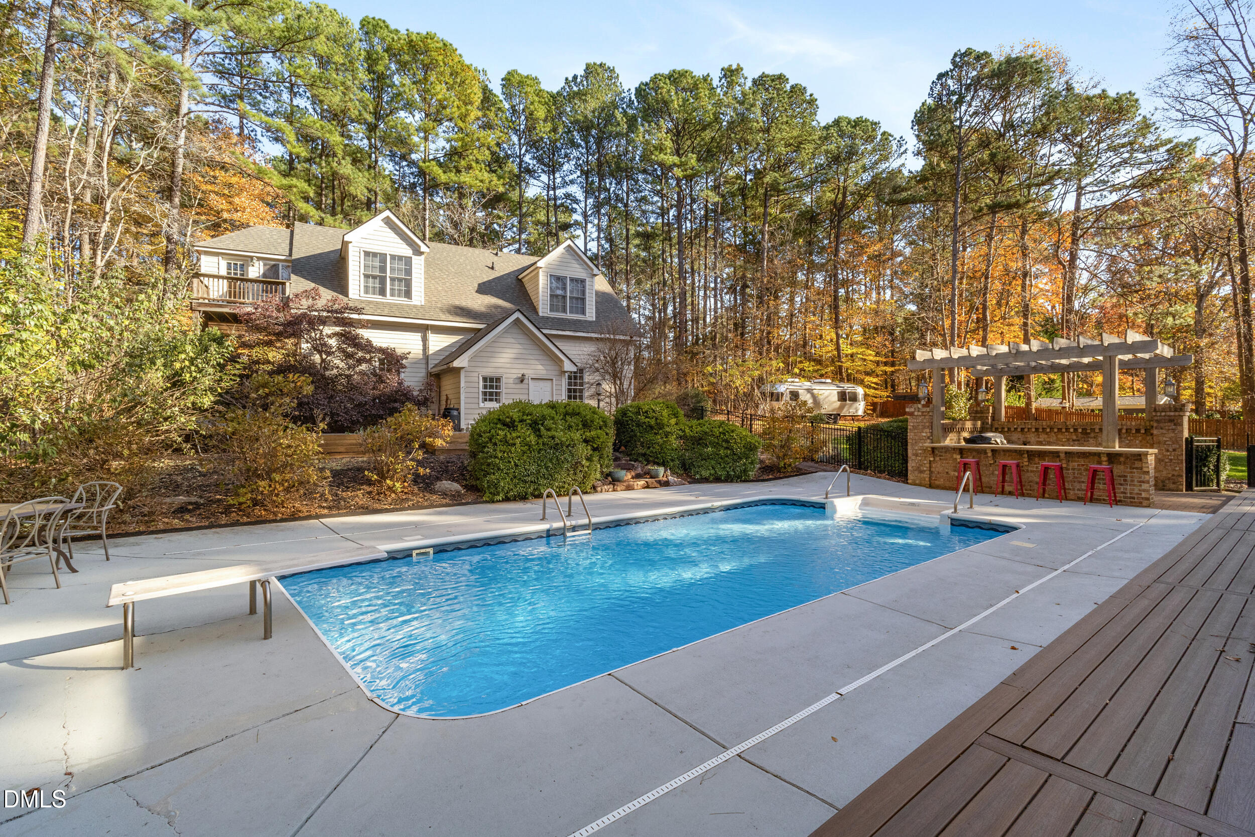 6816 Cool Pond Road Raleigh, NC 27613 - Photo 50 of 65 a view of a swimming pool with an outdoor space and seating area