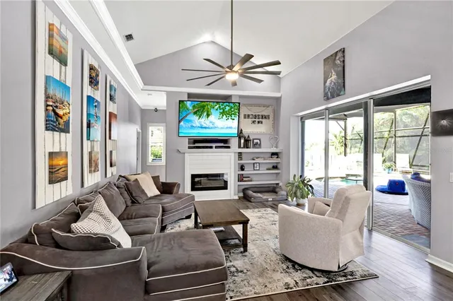 a living room with fireplace furniture and a large window