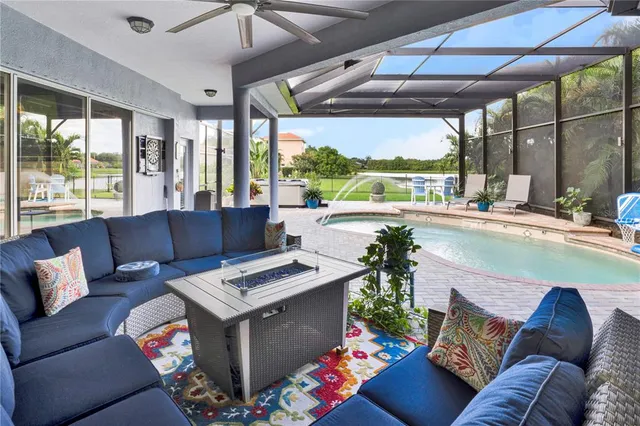 a living room with furniture and a floor to ceiling window