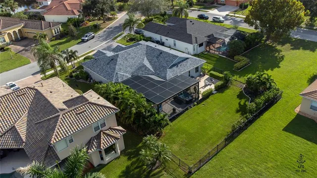 an aerial view of a house with outdoor space swimming pool and lake view