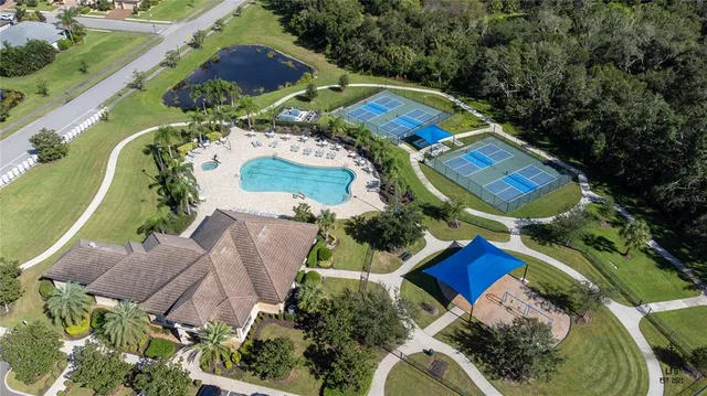 an aerial view of residential house with outdoor space and swimming pool