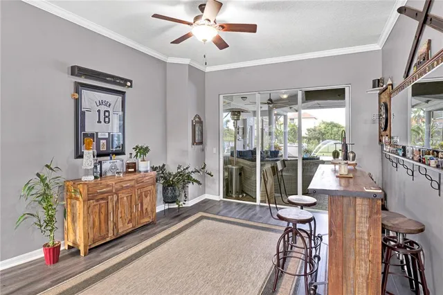 a living room with furniture a flat screen tv and a floor to ceiling window
